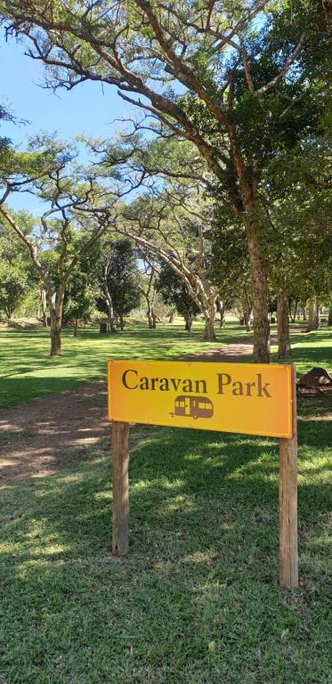a yellow park sign in the grass in a park at Elangeni Holiday Resort in Waterval Boven
