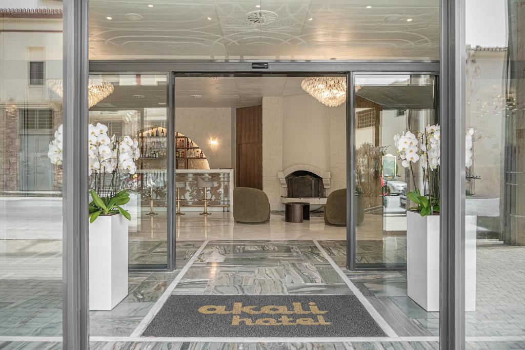 a lobby with glass doors and flowers in a store at Civitel Akali Hotel in Chania