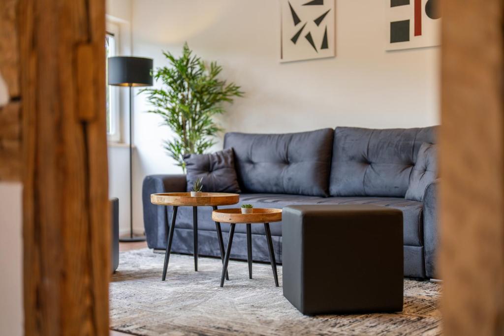 a living room with a blue couch and a table at Apartments im Gerberhaus in Coburg