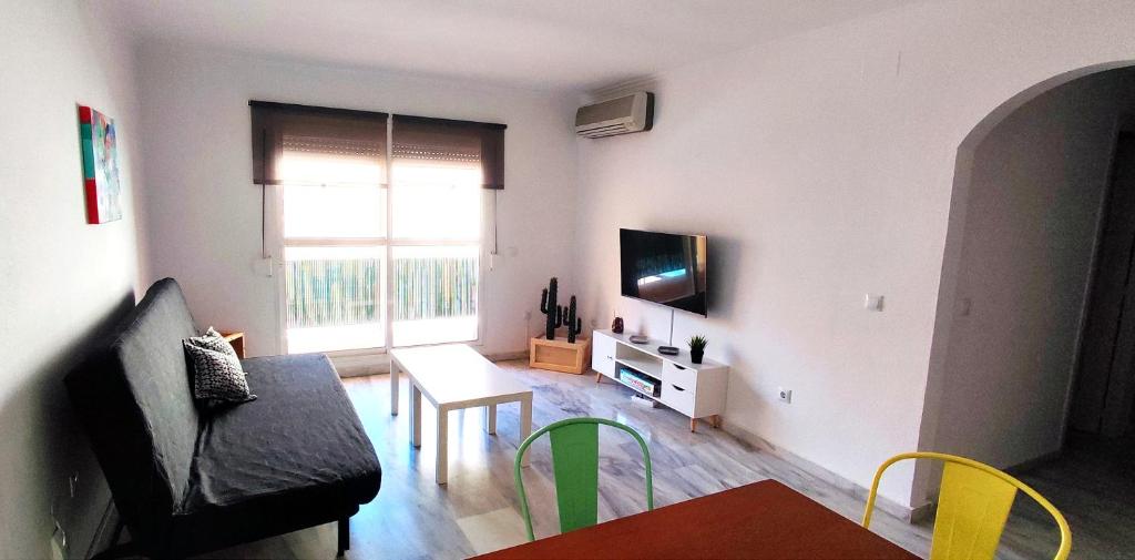 Televízia a/alebo spoločenská miestnosť v ubytovaní Apartamento Plaza Toros