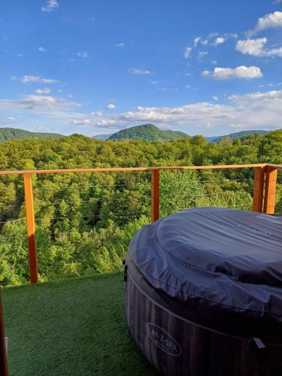 a bed on a balcony with a view of the mountains at Glamping Čelig 