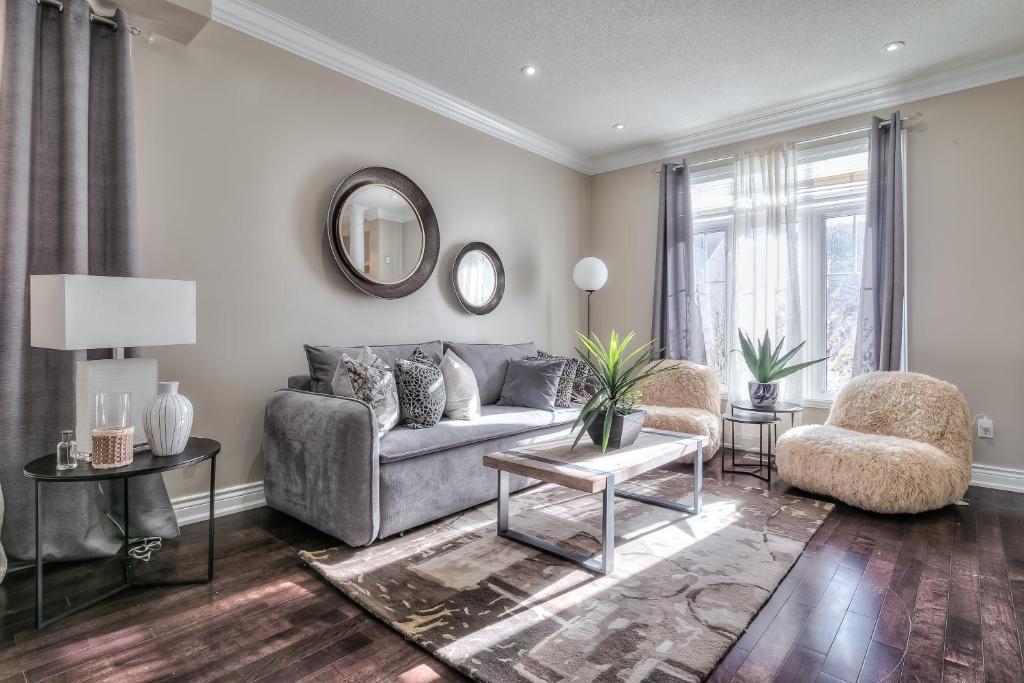 a living room with a couch and a chair at Premier Villas in Ajax