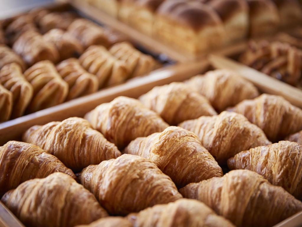 a bunch of pastries in trays in a bakery at Hotel Amsterdam Huis Ten Bosch in Sasebo