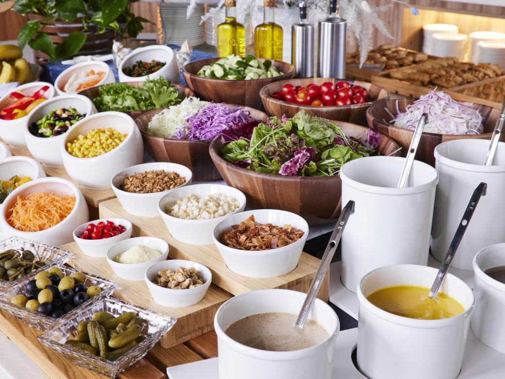 a buffet with bowls of different types of food at Hotel Amsterdam Huis Ten Bosch in Sasebo