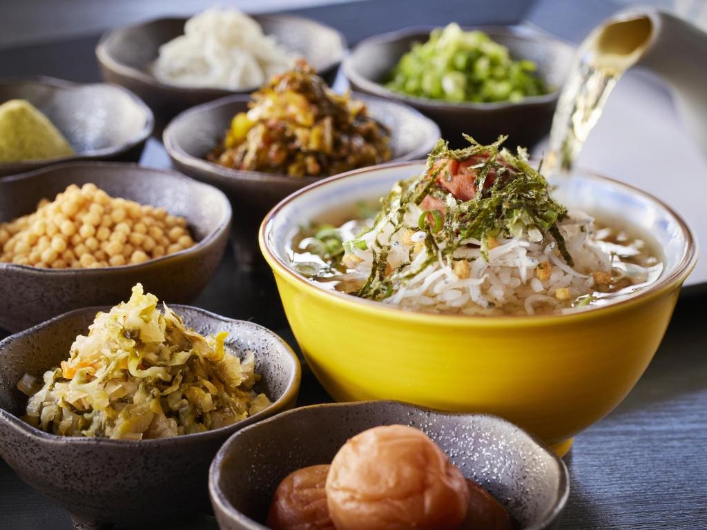 a table topped with bowls of different types of food at Hotel Amsterdam Huis Ten Bosch in Sasebo