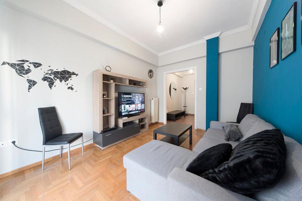 a living room with a couch and a tv at Central apartment 3' to Metaksourgio metro station in Athens