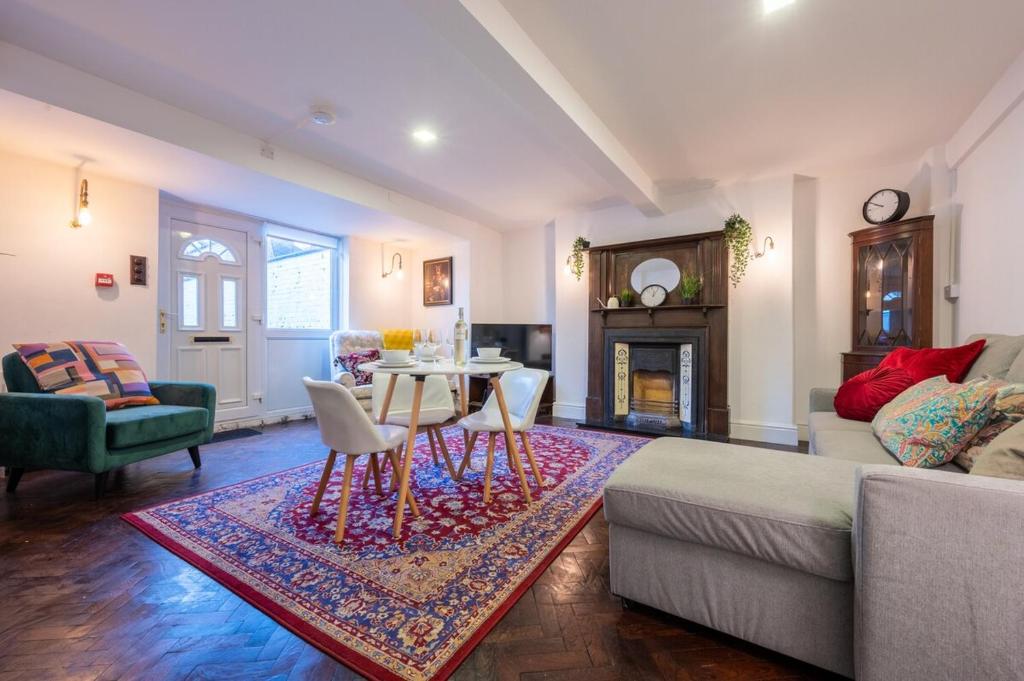 a living room with a couch and a table at Palmyra Square by Tŷ SA in Newport