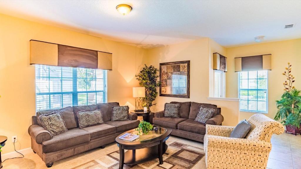 a living room with two couches and a table at Top Villas - Paradise Palms Resort 277 in Kissimmee