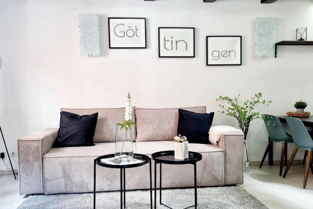 a living room with a couch and two tables at City Apartment in Göttingen in Göttingen