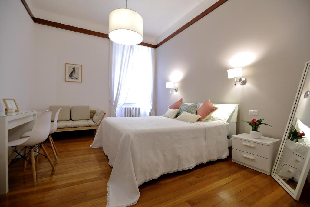 a bedroom with a bed and a desk and a mirror at Tata B&B in Rome