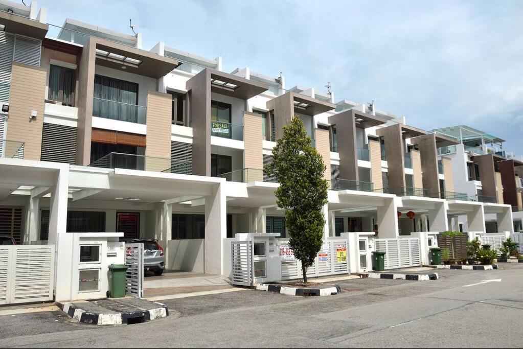 a large building with a tree in front of it at 5BR 3Storey Cozy Gelugor Homestay 15pax in Gelugor