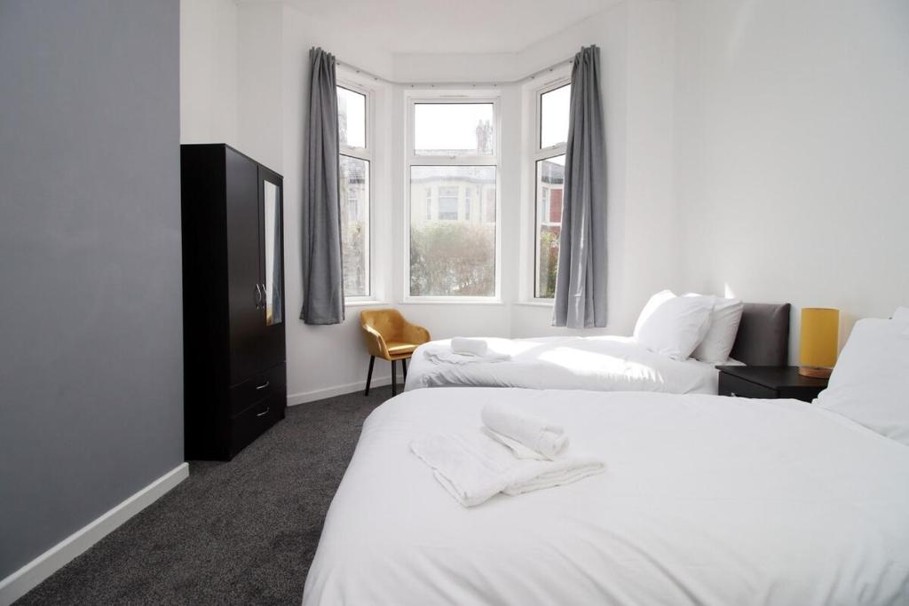 a hotel room with two beds and a window at Rugby Place by Tŷ SA in Newport
