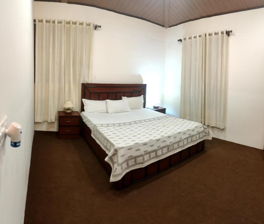 a bedroom with a large bed with a wooden headboard at BNB Room in Nainital