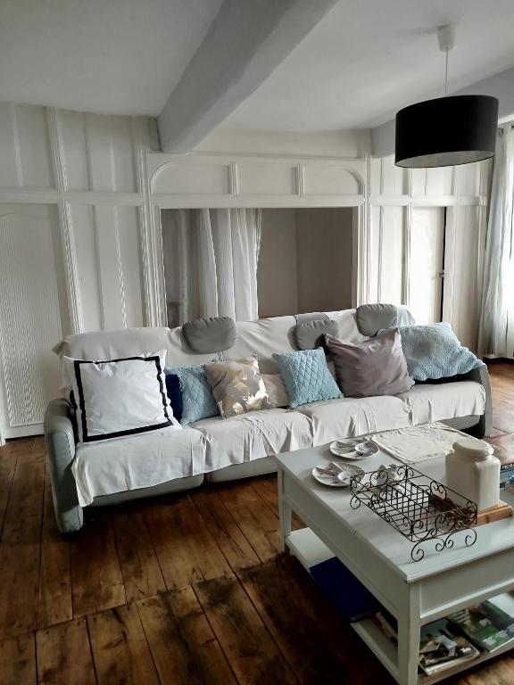 a living room with a white couch and a table at La Cadisserie en Gévaudan in Marvejols