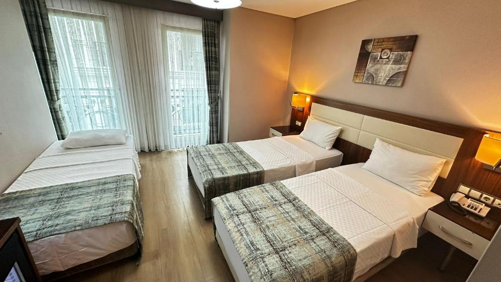 A bed or beds in a room at The Meretto Hotel Istanbul Old City