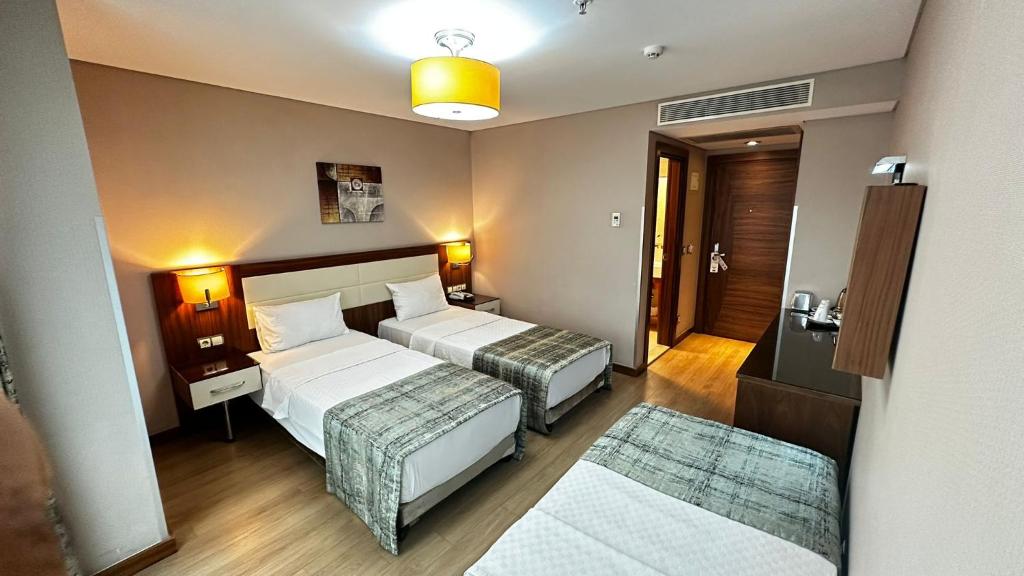 A bed or beds in a room at The Meretto Hotel Istanbul Old City