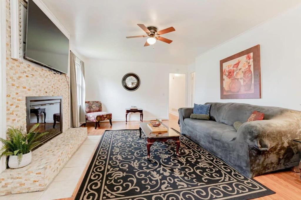 a living room with a couch and a fireplace at The Garnet Ranch Large Yard Near Jackson USC in Columbia