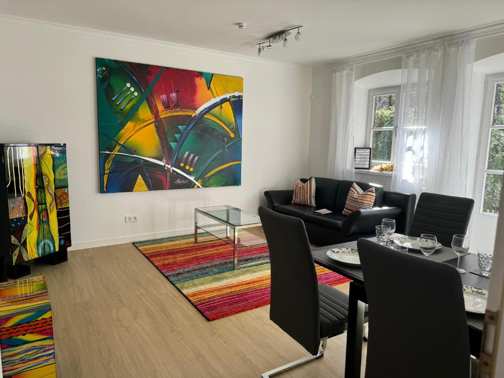 a living room with a painting on the wall at Ferienwohnung Kity mit Terrasse und Bergblick in Grainau