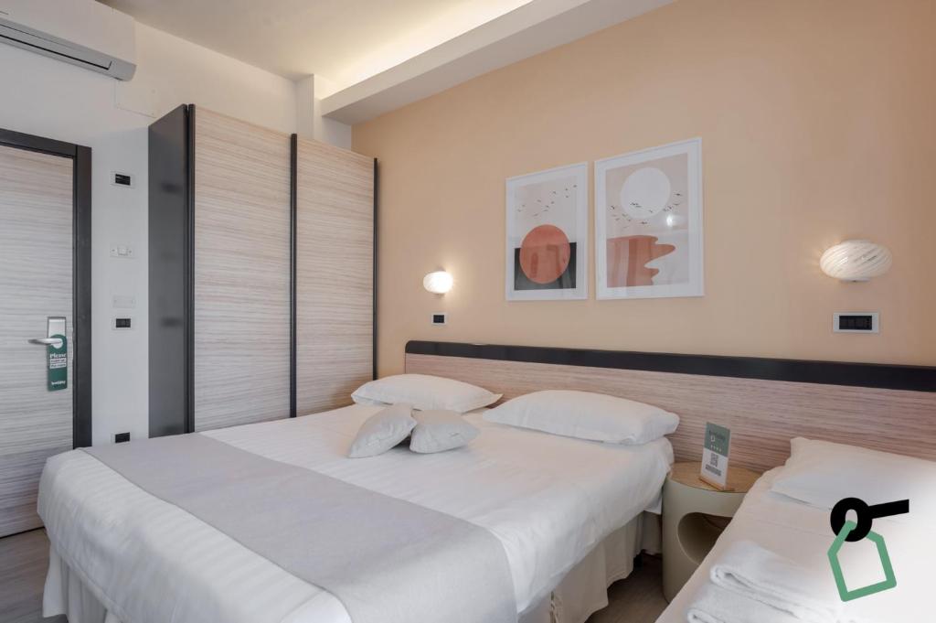Postel nebo postele na pokoji v ubytování HOTIDAY Room Collection - Giulianova