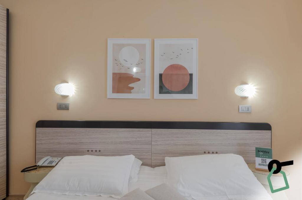 Postel nebo postele na pokoji v ubytování HOTIDAY Room Collection - Giulianova