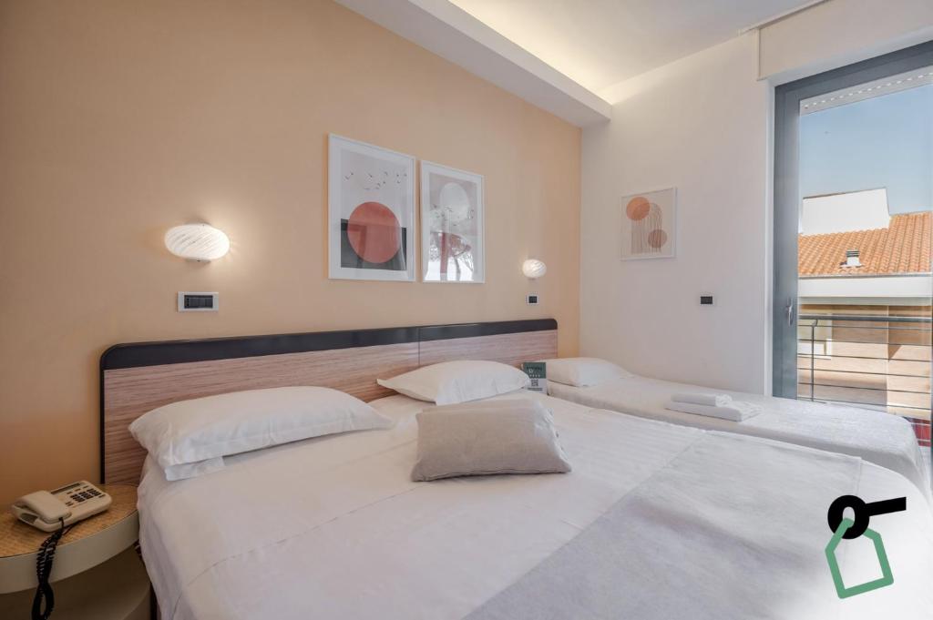 Postel nebo postele na pokoji v ubytování HOTIDAY Room Collection - Giulianova