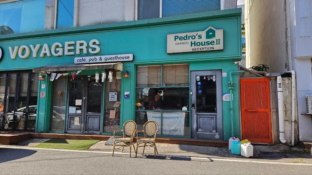 two chairs sitting in front of a building at Pedro's House - Foreigners only in Gwangju