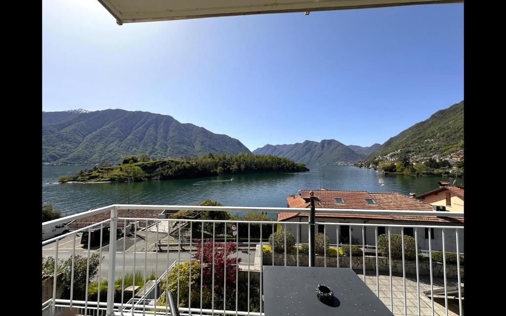 a view of a river with mountains in the background at Gardenia Apartment Ossuccio in Ossuccio