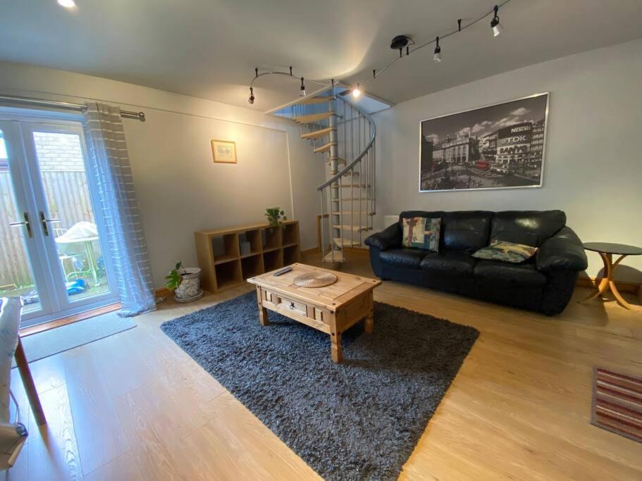 a living room with a couch and a coffee table at Professional 1-Bed Maisonette in Milton Keynes by HP Accommodation in Milton Keynes