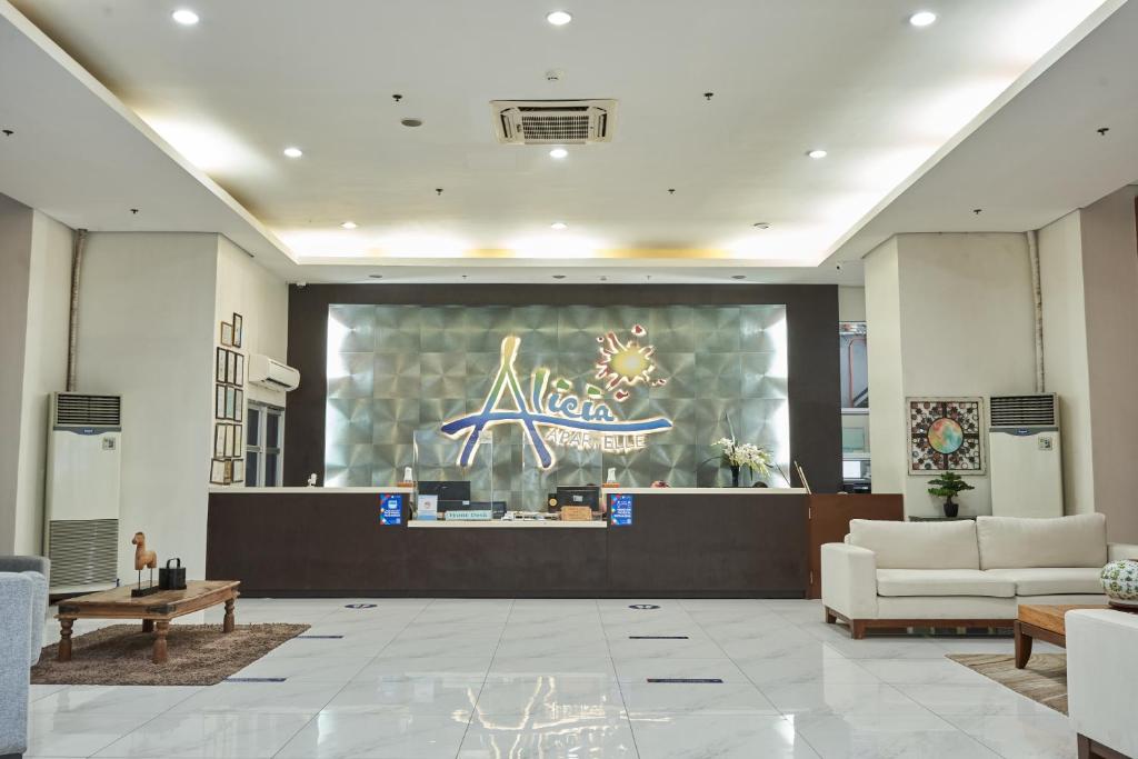 a lobby with a waiting area with a nike sign on the window at Alicia Apartelle in Cebu City