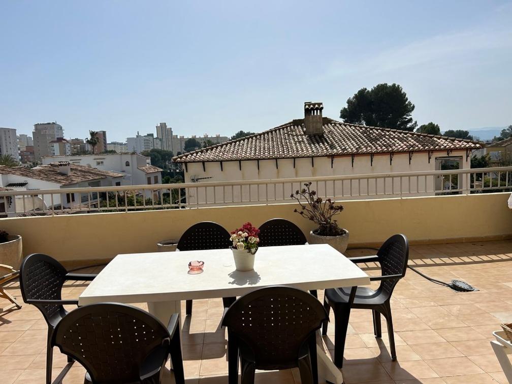 a white table and chairs on a patio with a view at Apartamento duplex LOS IRIS solo familias in Playa de Gandia