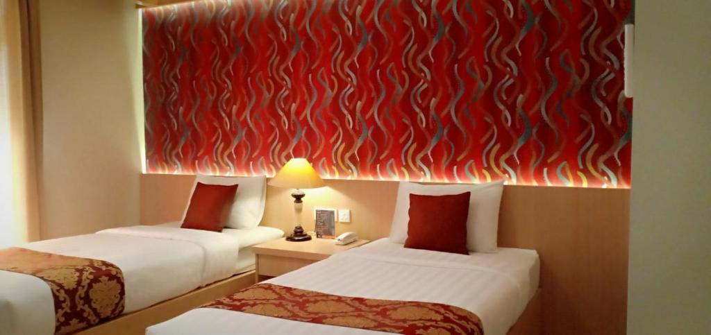 Säng eller sängar i ett rum på Votel De Bandungan Resort
