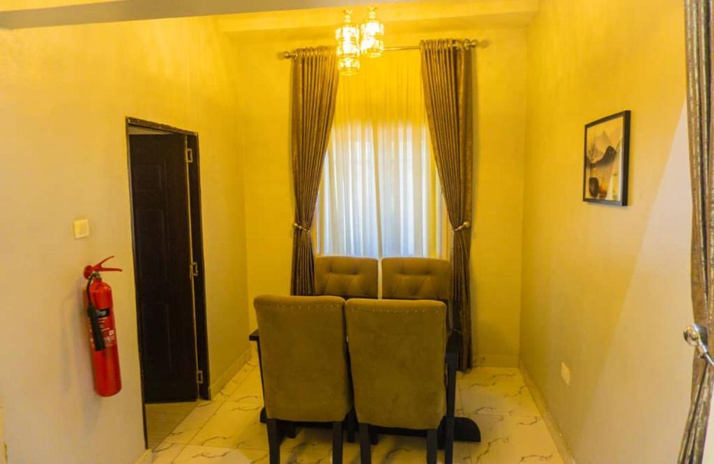 a living room with two chairs and a window at Exquisite luxurious 2 bedroom Apartment. in Gwarinpa