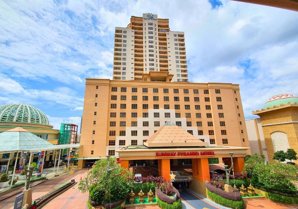a large building in front of a street with buildings at Sunway Studio Homestay with Balcony Theme Park View Connecting Sunway Pyramid Mall & Sunway Lagoon in Petaling Jaya