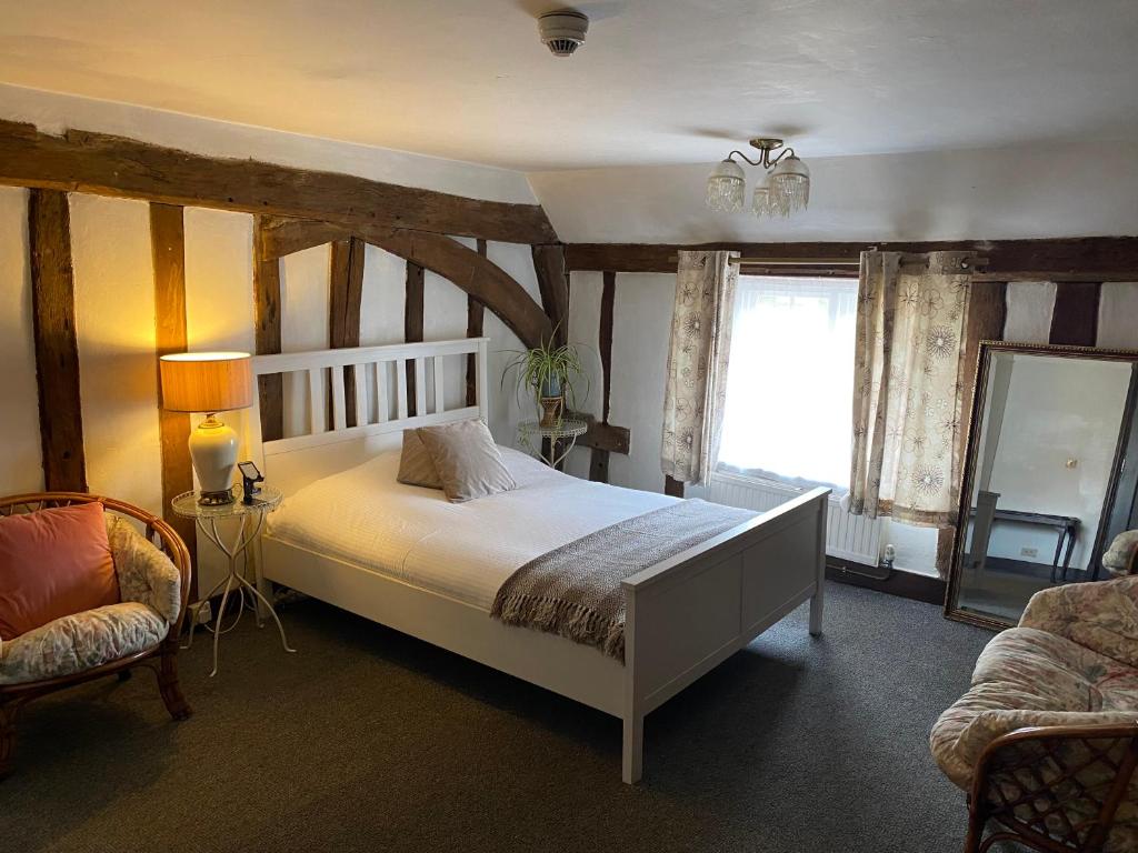 - une chambre avec un grand lit et une fenêtre dans l'établissement The Kentford, à Kentford