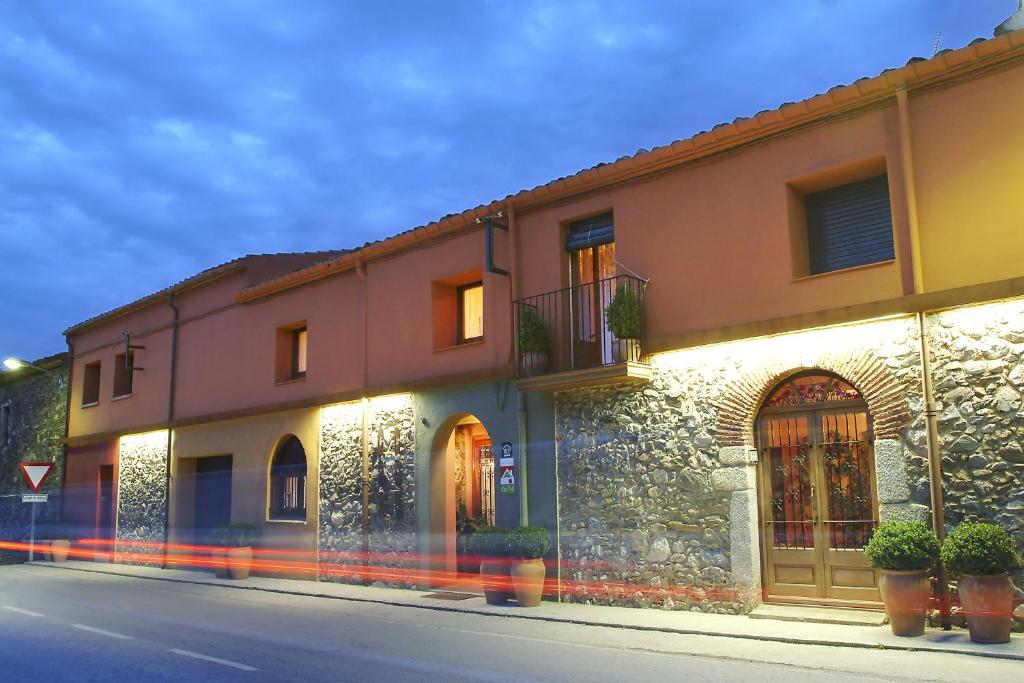 a building on the side of a street at Casa Rural Can Coll in Garriguella