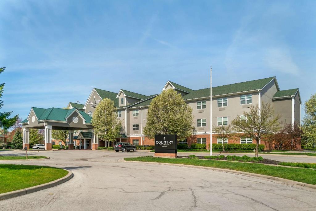 a large building with a sign in front of it at Country Inn & Suites by Radisson, Toledo South, OH in Rossford