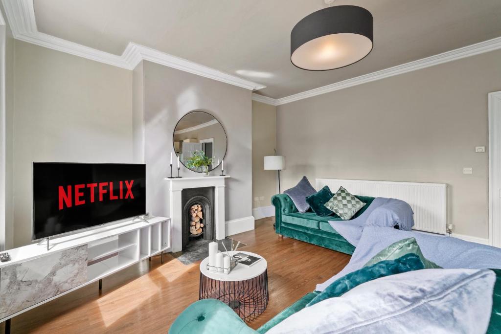 a living room with a couch and a fireplace at Boutique and Stylish Wakefield Apartment in Wakefield