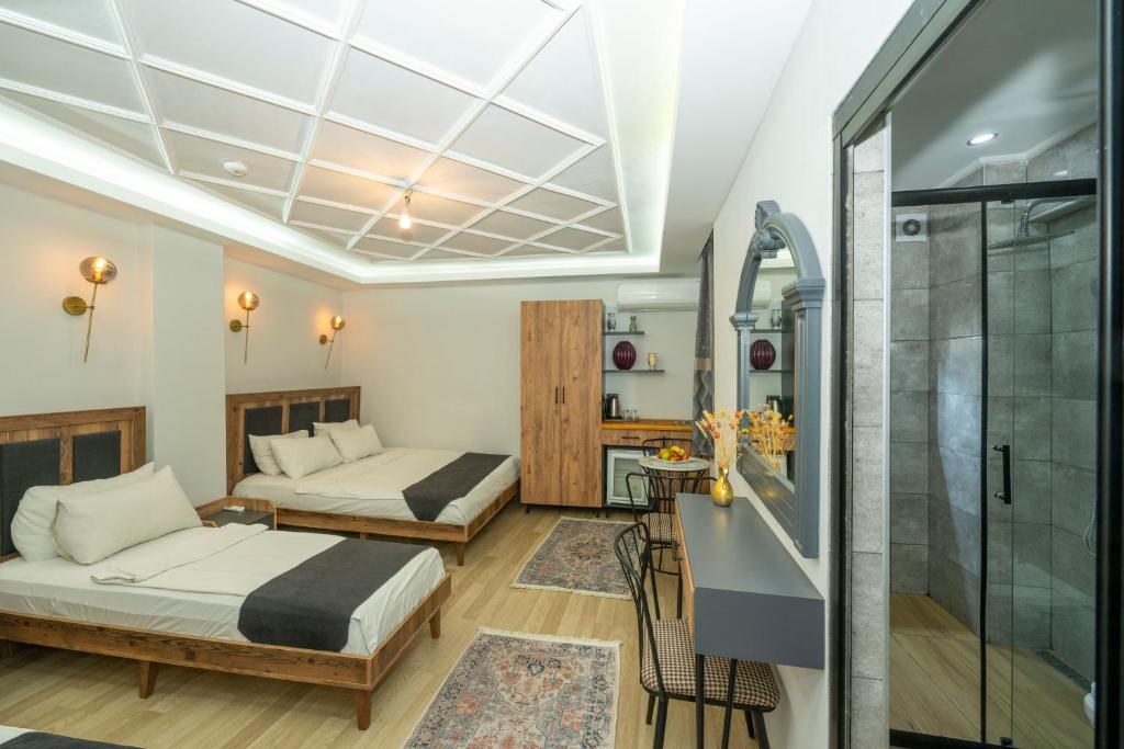 a hotel room with two beds and a shower at Valeria House in Istanbul