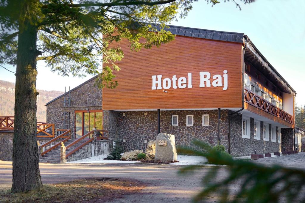 a building with a hotel ral sign on it at Hotel Raj in Dedinky