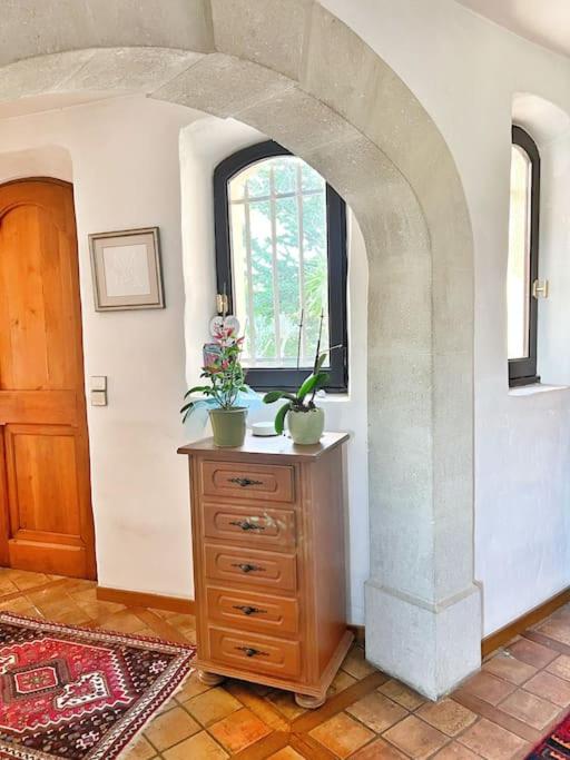a room with a wooden dresser and a window at Magnifique villa avec Piscine Vue mer in Sanary-sur-Mer