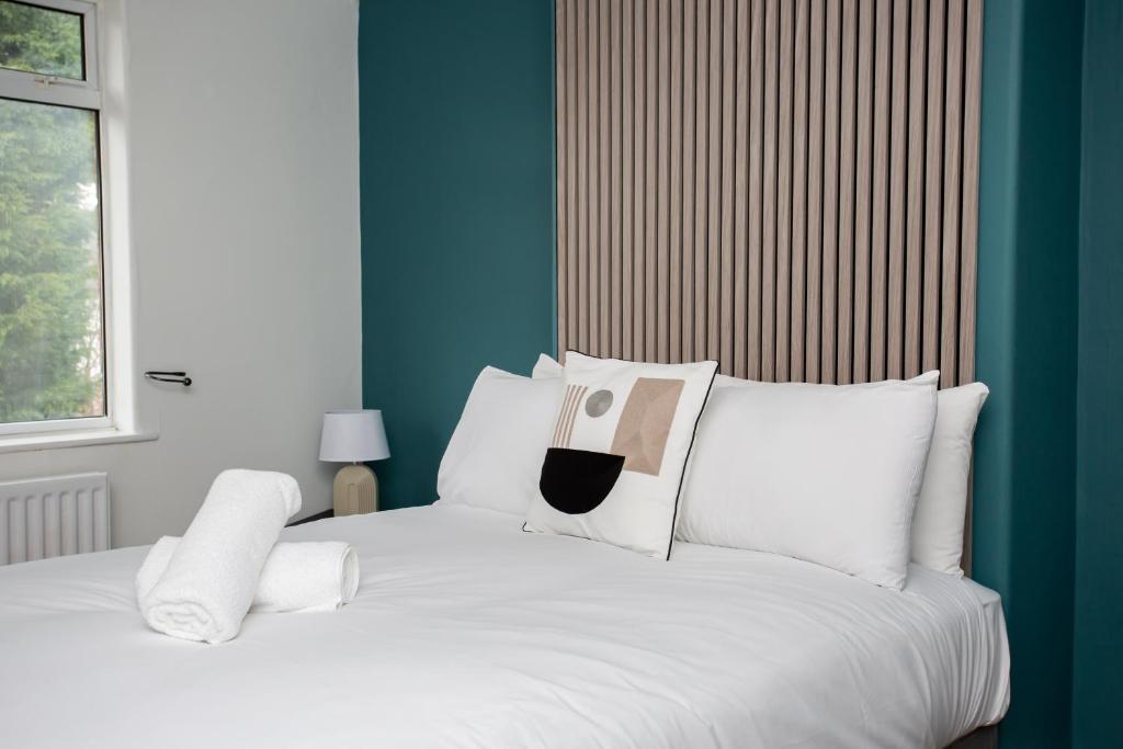 1 dormitorio con 1 cama blanca y paredes azules en Modern 3-bedroom Retreat, en Swalwell