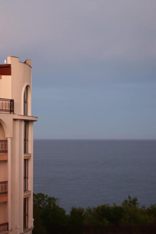 a building with the ocean in the background at Apart Hotel Apolonia Palace in Sinemorets