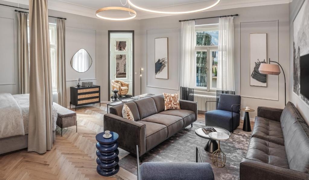 a living room with a couch and a bed at River Dance Suites by Adrez in Prague