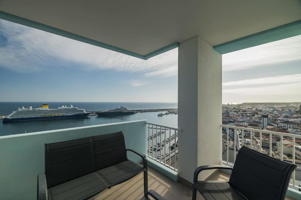 a balcony with a bench and a cruise ship at Ocean Vista - Premium CityCenter in Ponta Delgada