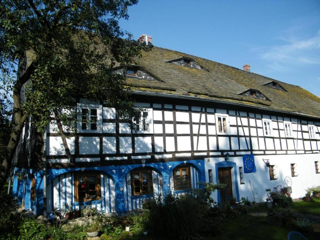 a large white and blue building with a roof at Gesamtes Ferienhaus in Wolimierz mit Offenem Kamin in Świeradów-Zdrój