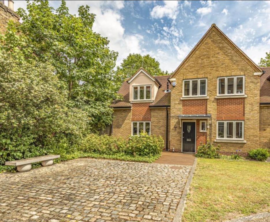 a large brick house with a stone driveway at Welcome To Your Home in London