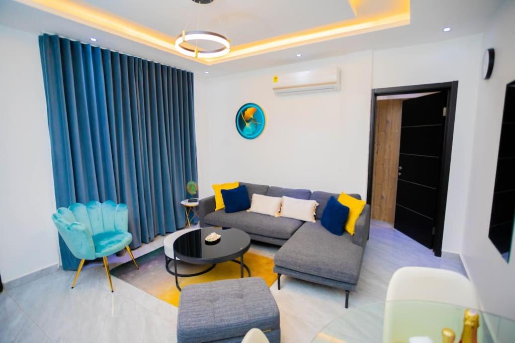 a living room with a couch and chairs and a table at The Pearl - Legacy - 4th floor in Kumasi