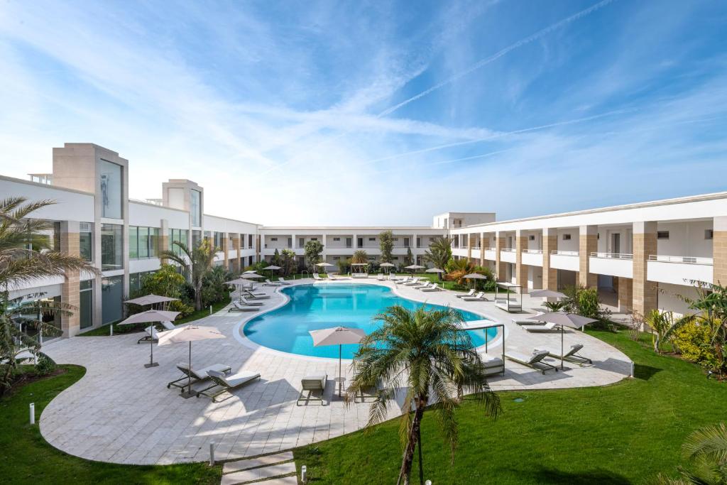 an image of the courtyard of a building with a swimming pool at Torre Assunta Hotel in Gallipoli
