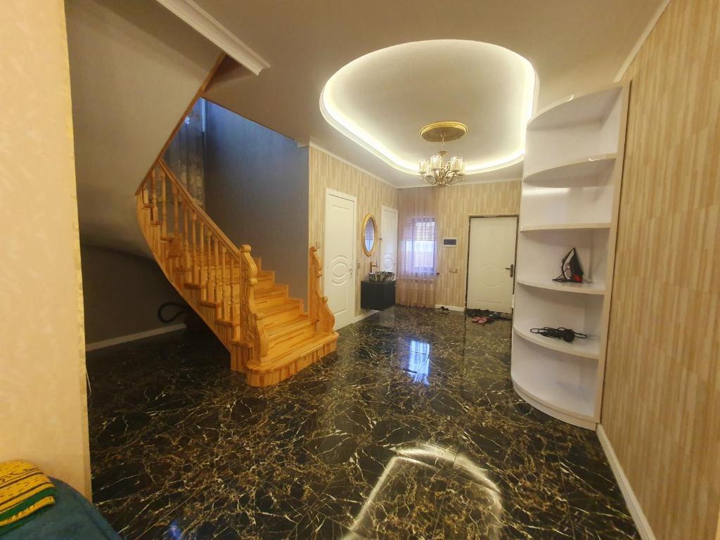 a hallway with a staircase in a house at Luxury Forestside Villa in Quba