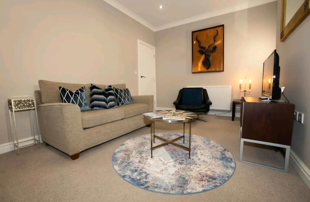a living room with a couch and a table at Stones Throw in Scarborough